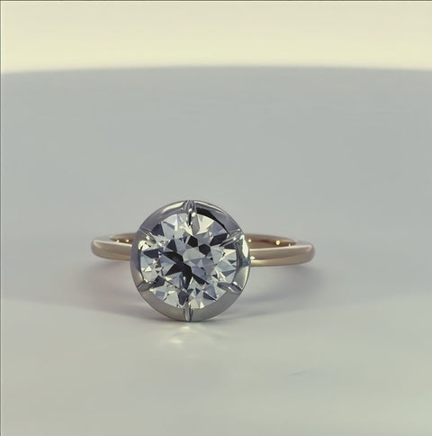 short video of a white and yellow gold ring with a diamond center rotating on a white background.
